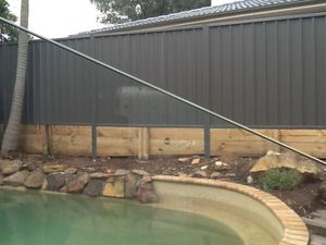 Colorbond fence above a treated pine sleeper retaining wall, Baulkham Hills