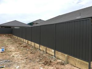 Colorbond fence with timber sleeper retaining wall