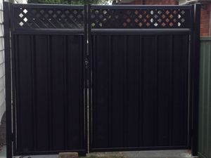 Black Colorbond gate with lattice inserts
