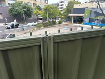 Close view of a pale green Colorbond post and top rail junction