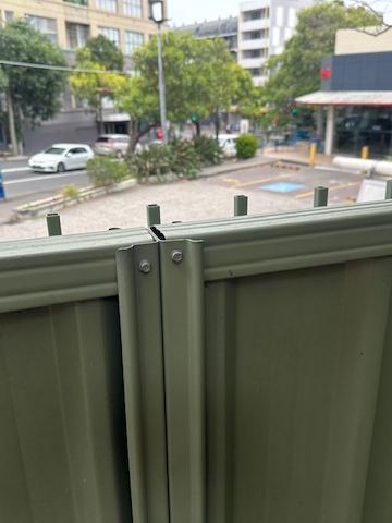 Close view of a pale green Colorbond post and top rail junction