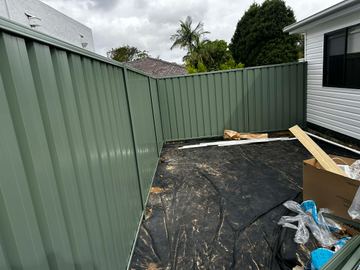 A mid grey Colorbond fence on a residential boundary