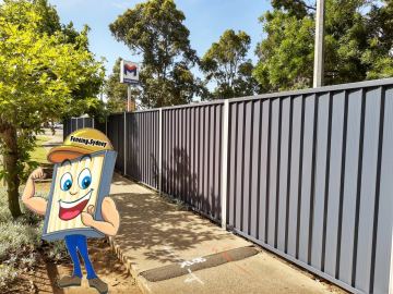 The scene shows a mid grey corrugated steel fence where sleepers form the base.