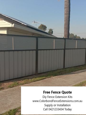 Grey Colorbond privacy fence with a matching slat height extension along a street