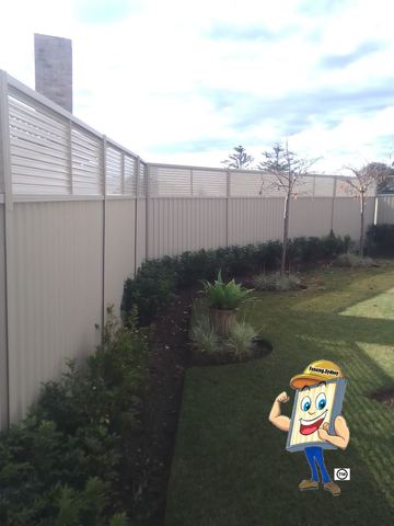 Cream Colorbond privacy fence with a full slat height extension in a garden