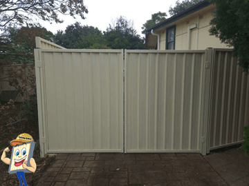 Cream Colorbond double driveway gate on a suburban drive