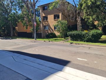 Residential street and apartment building before boundary fence work