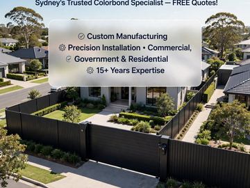 Aerial view of a charcoal Colorbond privacy fence beside a concrete driveway