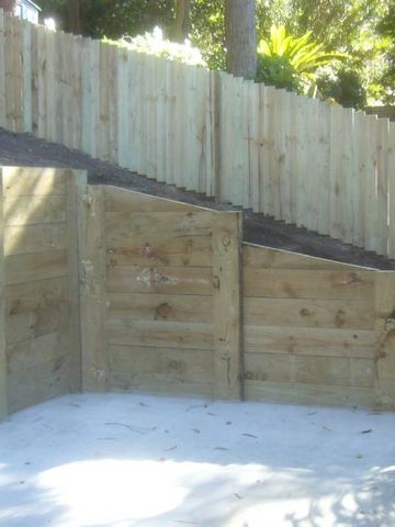 New treated pine paling fence enclosing an empty pool excavation