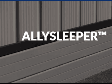 Close view of Colorbond sheets sitting above an aluminium sleeper retaining system