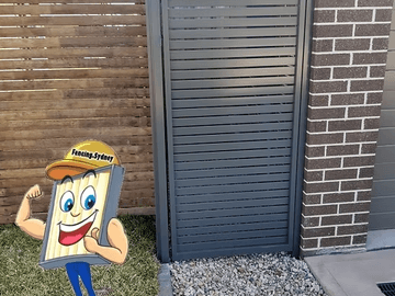 Horizontal slat gate set between a brick wall and a timber slat fence with pebble paving.