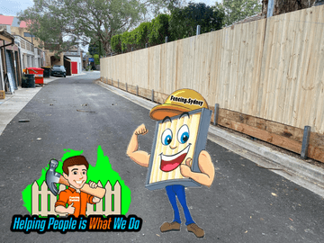 New treated pine palings beside paved areas.