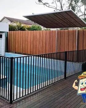 Black tubular pool fencing on a wet deck sits below a tall timber-look slat screen and angled awning.